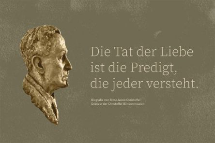 Bronzebüste, daneben der Schriftzug: Die Tat der Liebe ist die Predigt, die jeder versteht.