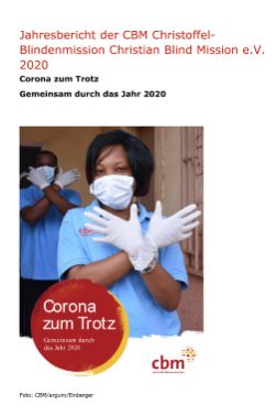 Eine Frau mit Mund-Nasen-Schutz kreuzt die Arme vor der Brust, die Hände in Einmalhandschuhen; auf einem roten Punk steht: Corona zum Trotz