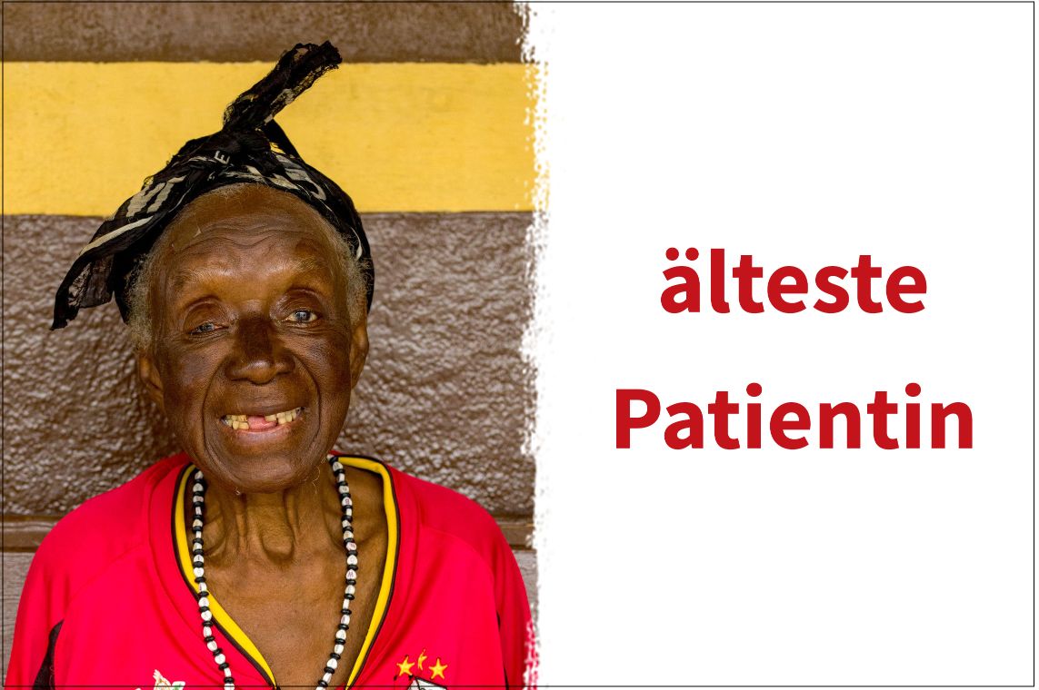 Eine alte, bunt gekleidete afrikanische Frau, die lächelt.