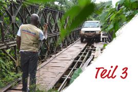 Ein Auto fährt über eine Brücke. An der Seite steht: Teil 3