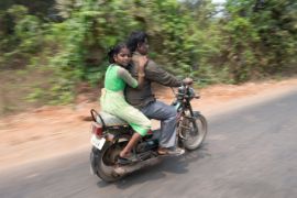 Ein Mann und ein Mädchen auf einem Moped