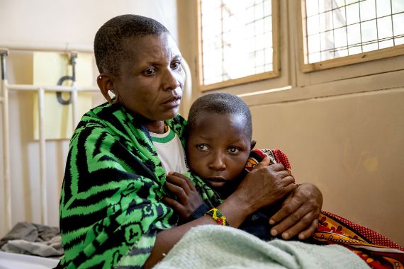 A woman comforting her daughter in hospital