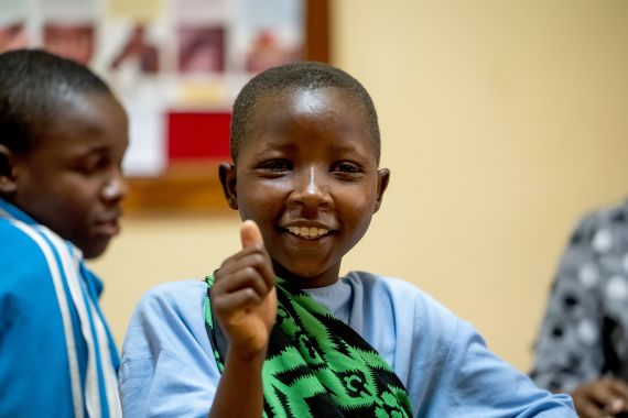 A girl giving a thumbs up 